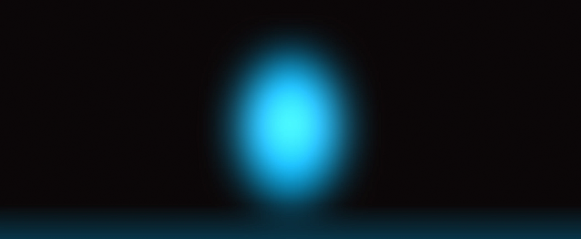 A soft, glowing blue oval light or spotlight on a solid black background.