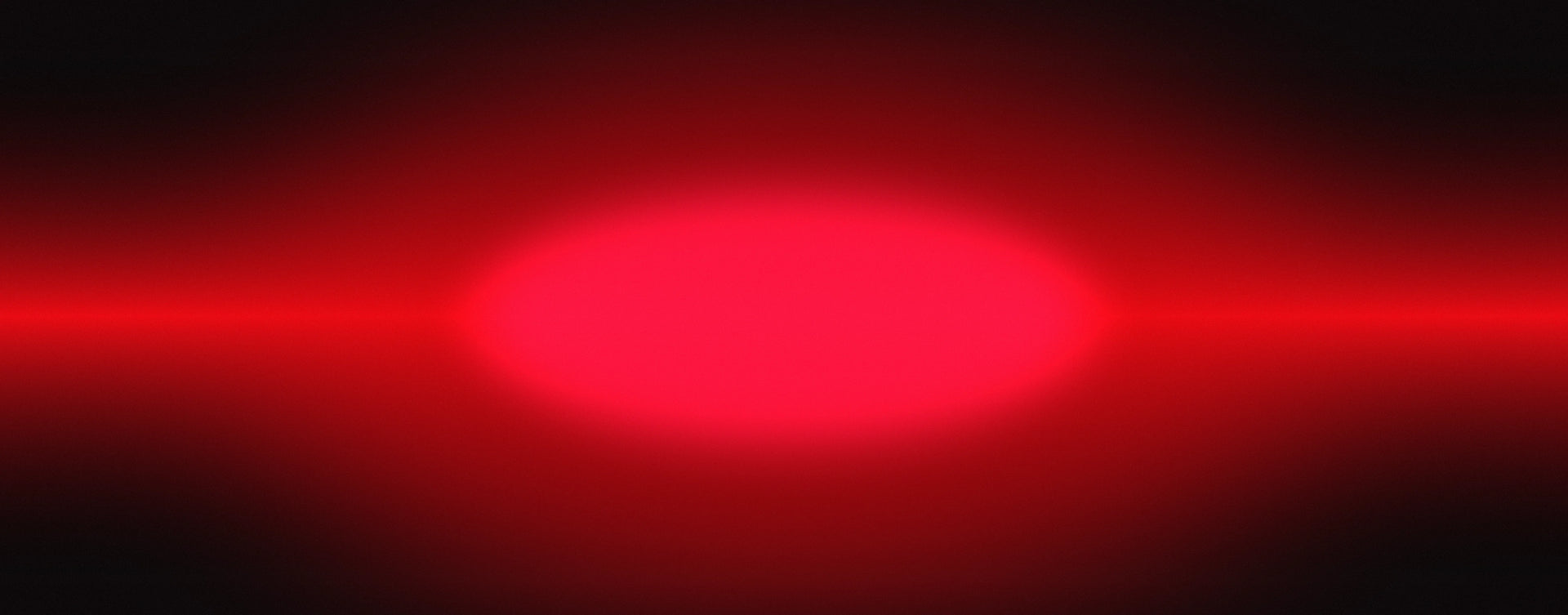 A glowing red oval light centered on a dark black background with horizontal red light streaks extending left and right.