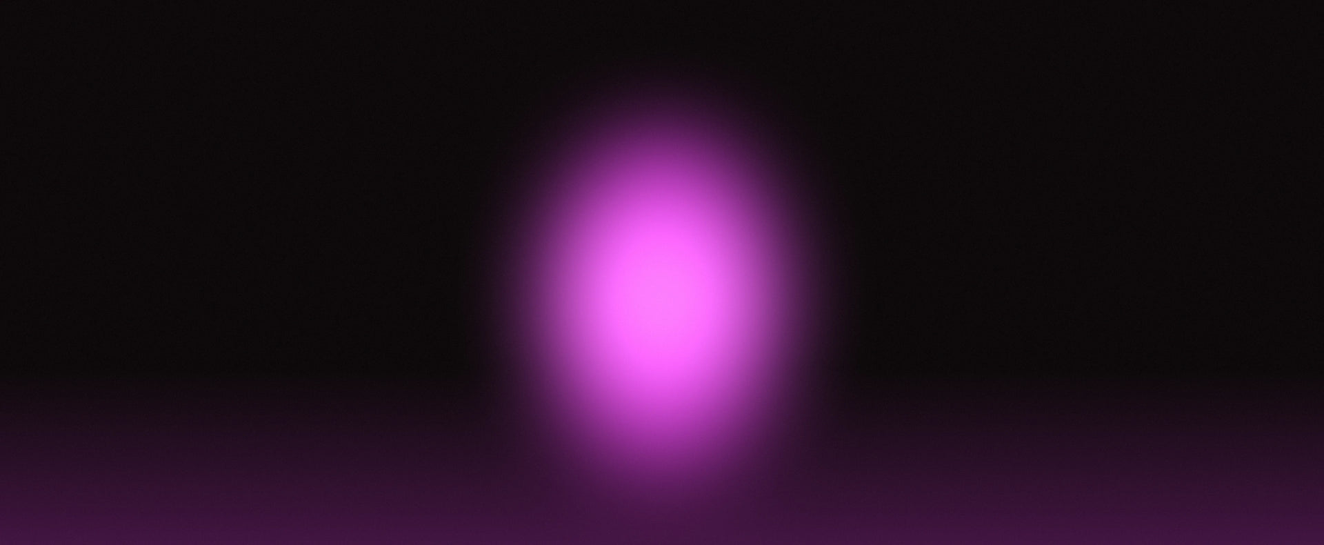 A soft, glowing purple oval light spot centered on a black background.